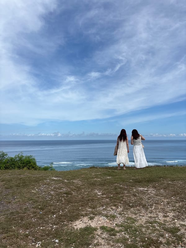 Two women photograph coastal visit in Kuta Selatan