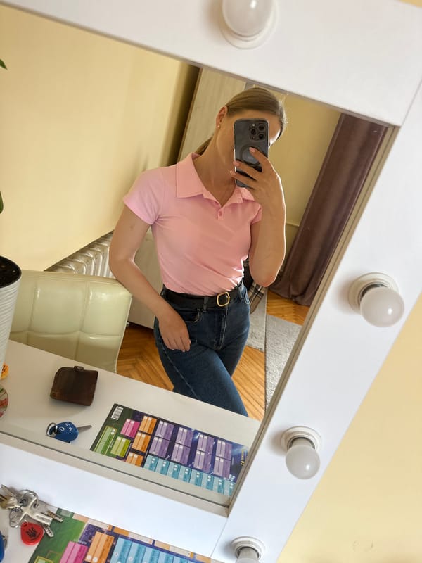 Woman photographs herself and gray cat in Ternopil apartment