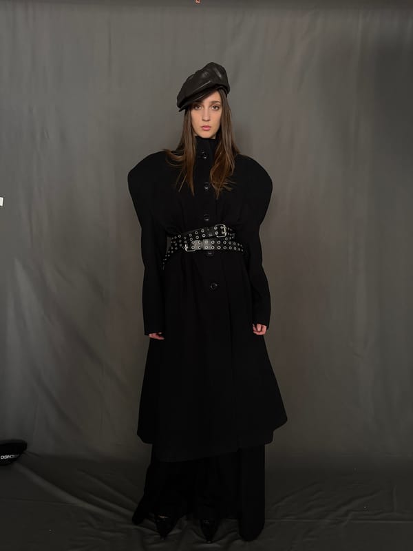 Woman photographed in black outfit during studio session