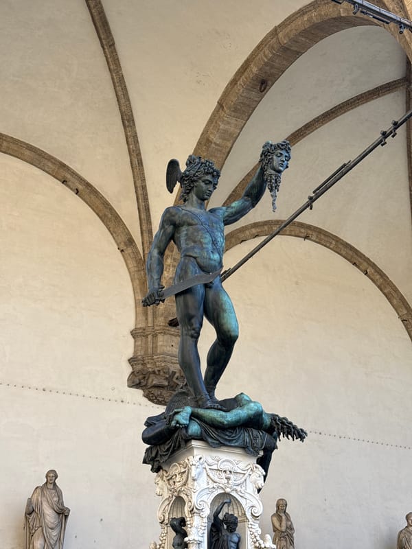 Tourist documents famous Perseus statue in Florence's historic square