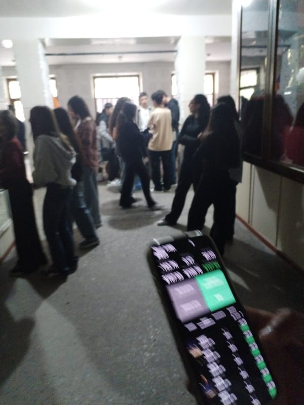 Young people gather in institutional building hallway