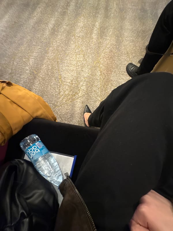 Person seated with belongings in early morning Yerevan scene