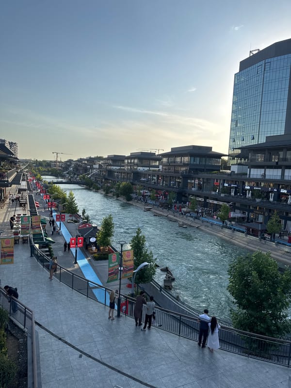 Riverside promenade and mall buzz with food mascots and foot traffic
