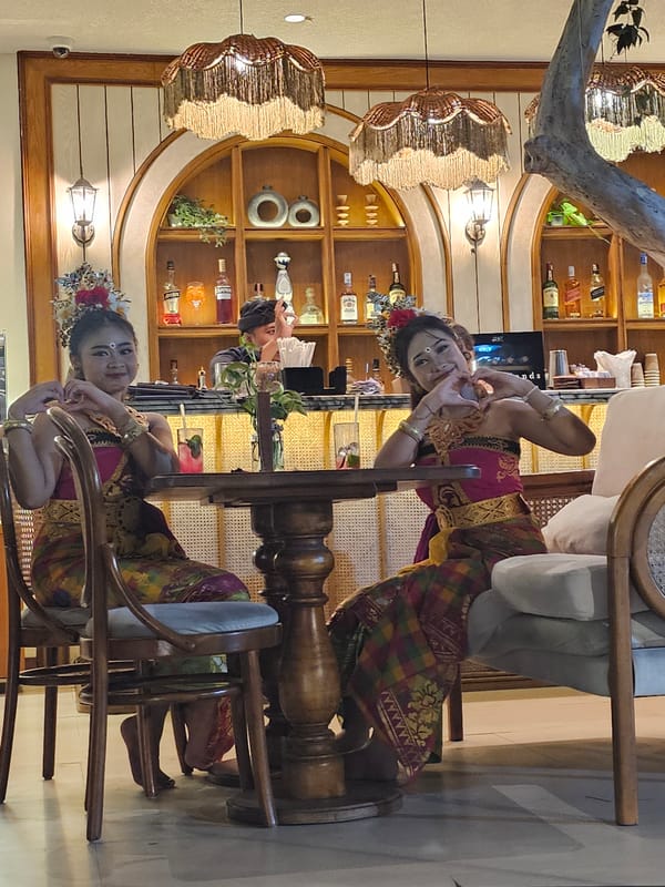 Evening restaurant scene with traditional dress and live music in Denpasar