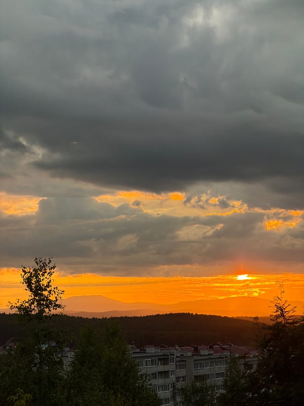 Dramatic sunset over a hilly city, caught from multiple angles