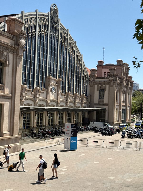 Sunny day outside a grand ornate building in Barcelona