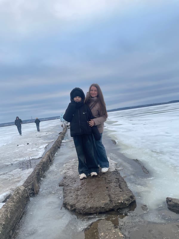 People pose on frozen waterfront in Izhevsk, Russia