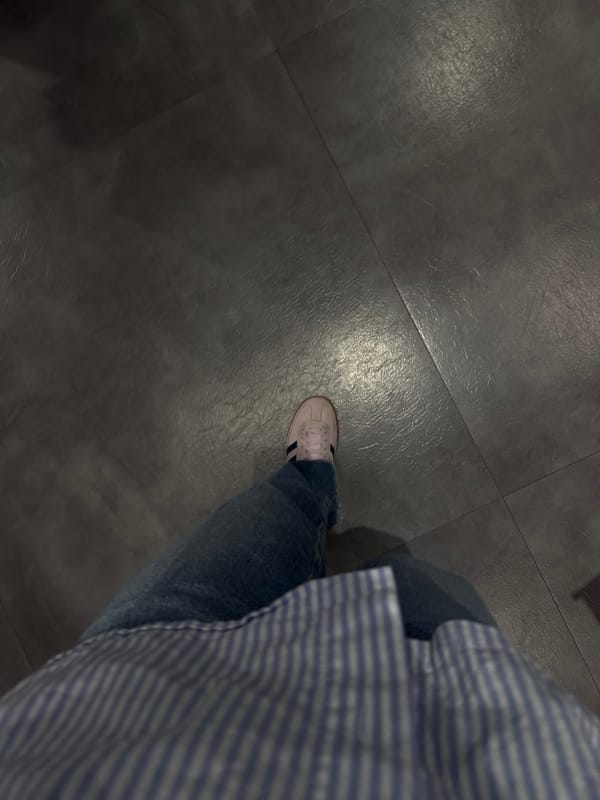 Person in striped shirt observed on tiled floor