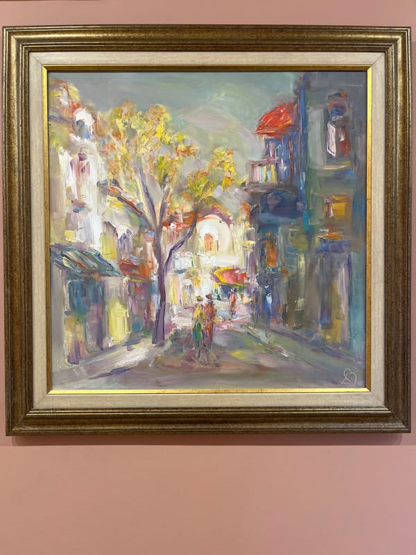 Oil paintings displayed on pink walls in Plovdiv