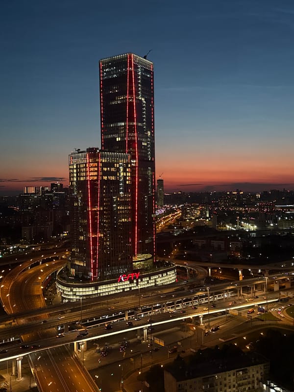 Moscow City towers glow red in paired aerial night shots