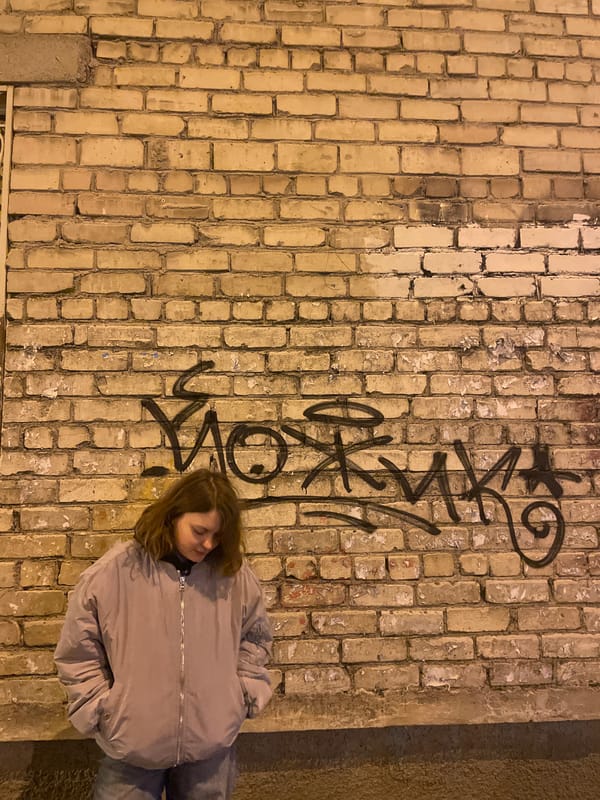Woman photographed against graffiti wall in Yekaterinburg