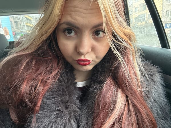 Woman takes upside-down selfies in car during rainy Sofia morning