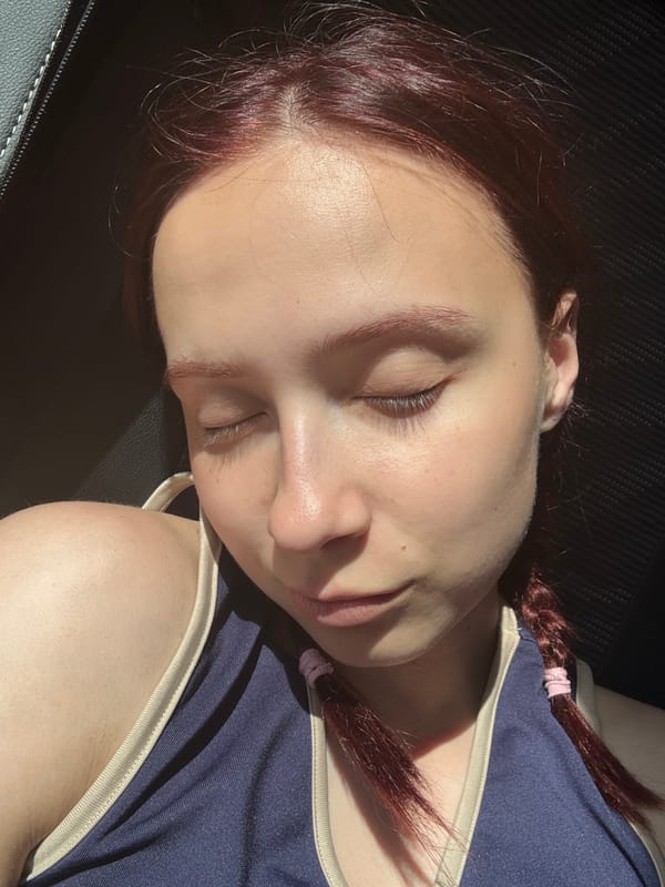 Person with burgundy braids resting in Можга, Russia