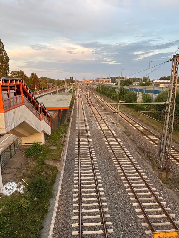 Railway tracks at golden hour, ground to aerial.