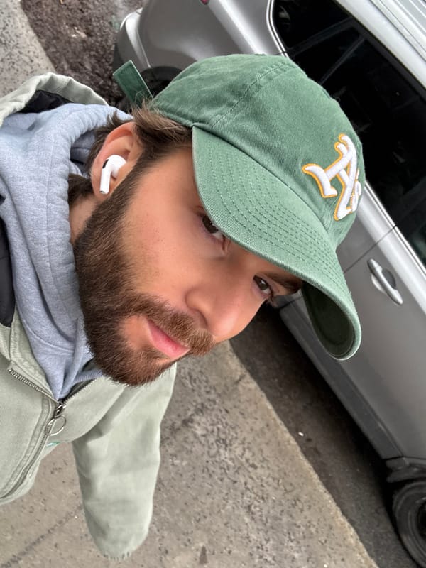 Man Takes Selfie in Green Cap in Montreal