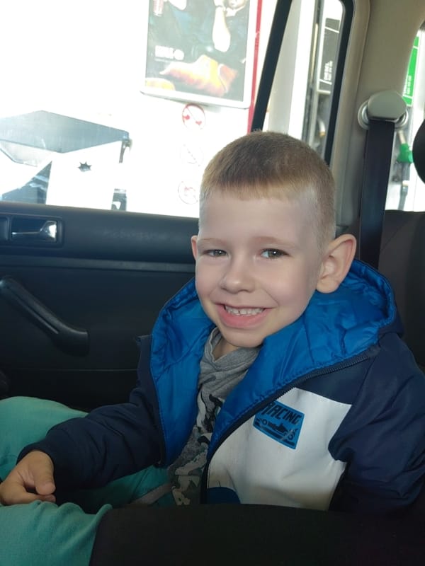 Boy and dog captured during early morning car journey
