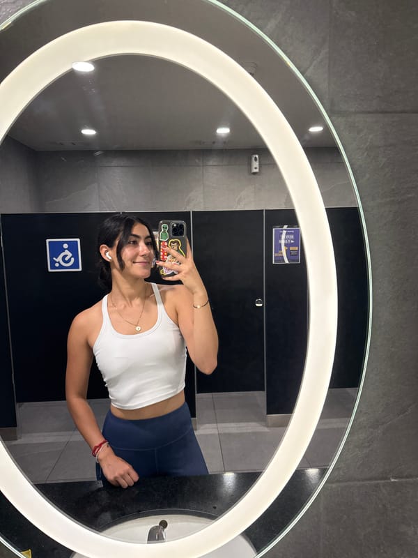 Woman takes selfie in Puebla restroom mirror