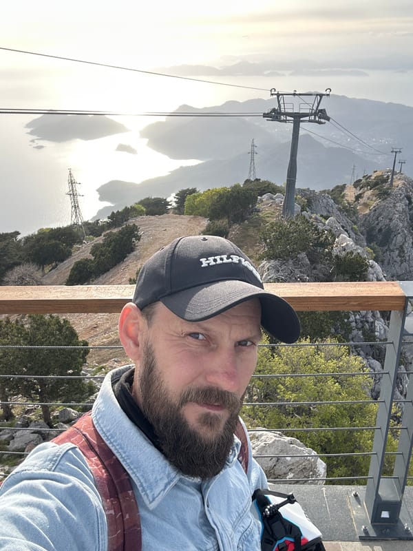 Visitors document scenic cable car station overlooking Fethiye coastline
