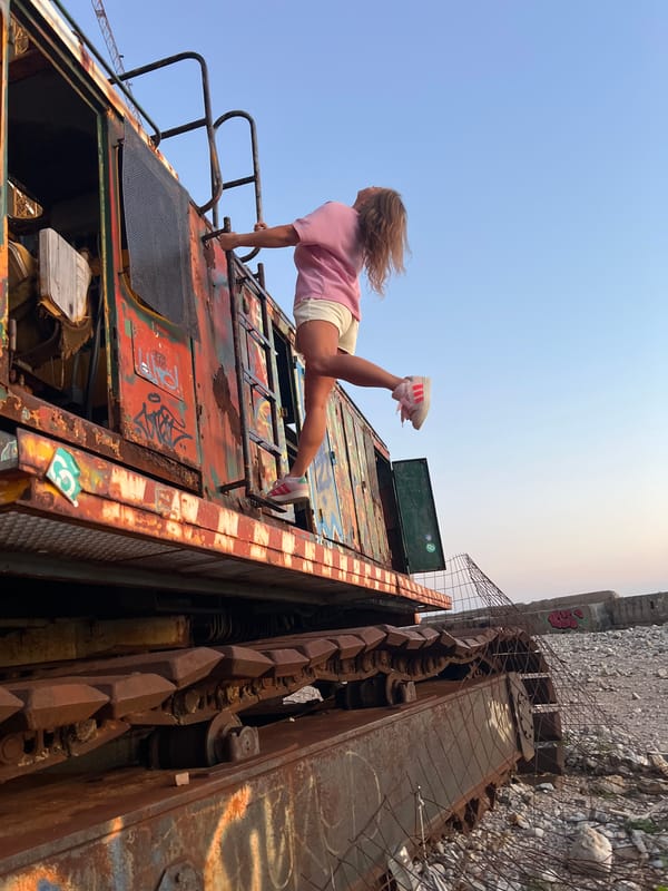 Woman enjoys kiwi drink at Montenegro beaches during sunset