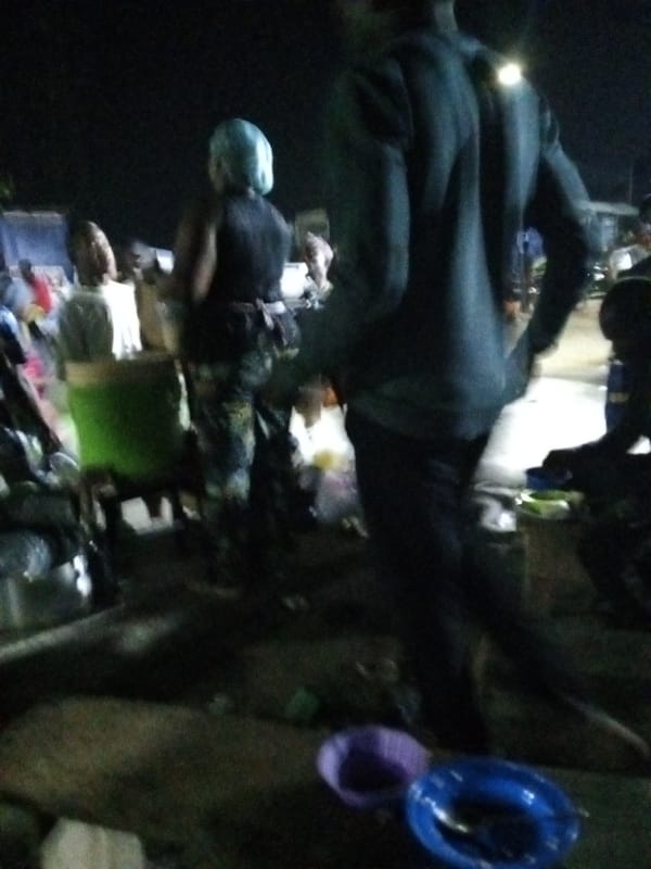 Evening street life unfolds in Ado, Nigeria commercial district