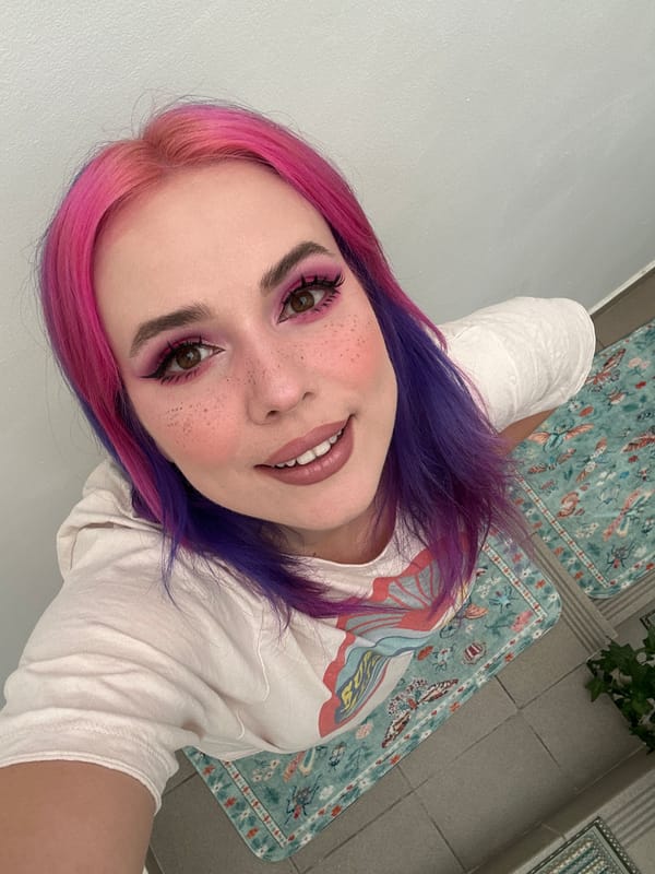 Woman with colorful hair takes selfies in Zagreb