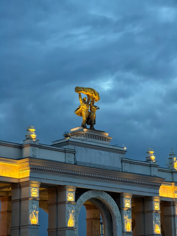 Golden-lit Soviet statue documented at Moscow's VDNKh entrance