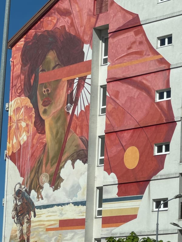 Multi-story mural documented on building facade in Sirius, Russia