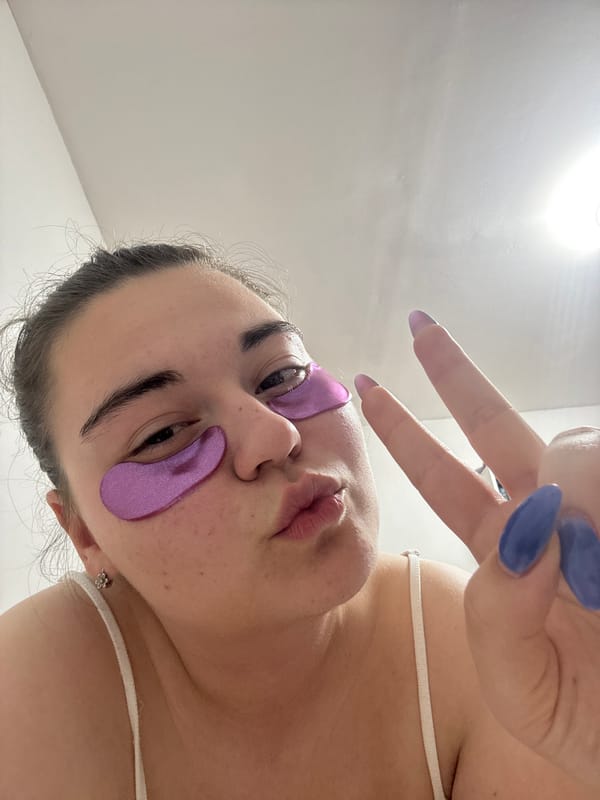 Woman applies purple under-eye patches in Zlatitsa beauty routine