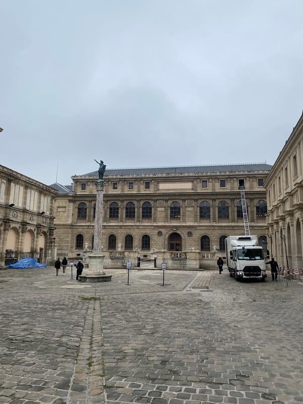 Classical Parisian architecture with statue column documented