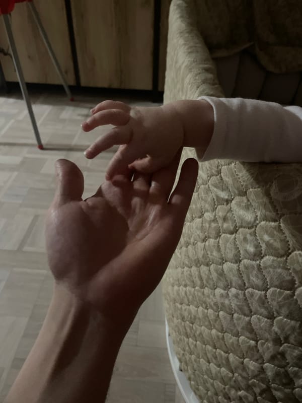 Evening domestic moments: baby in crib, noodle cooking