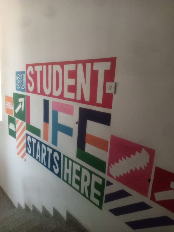 Student facility interior documented in Abuja showing motivational displays