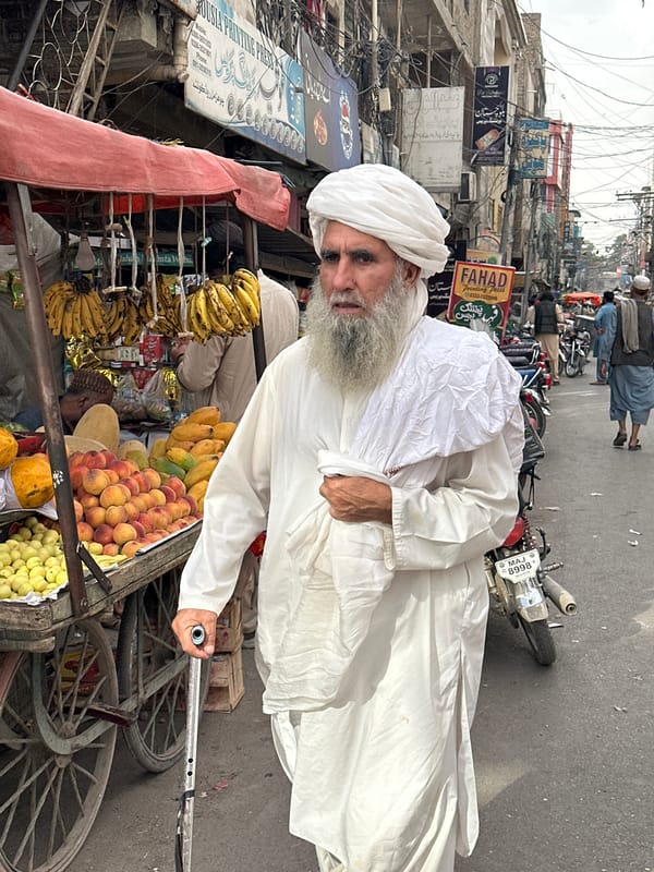Elderly vendor conducts daily business on Quetta streets