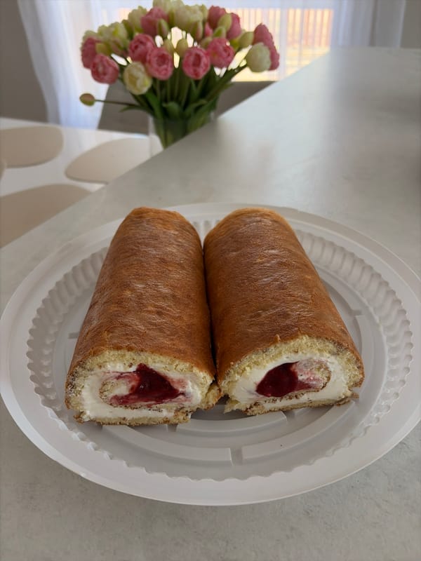 Swiss roll cake slices documented on white plate