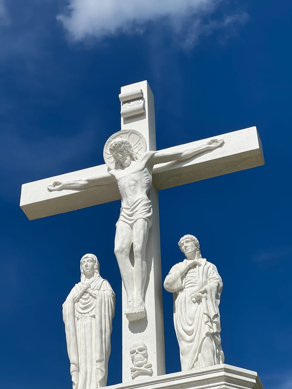 Crucifixion monument and summer blooms in Rezina, Moldova