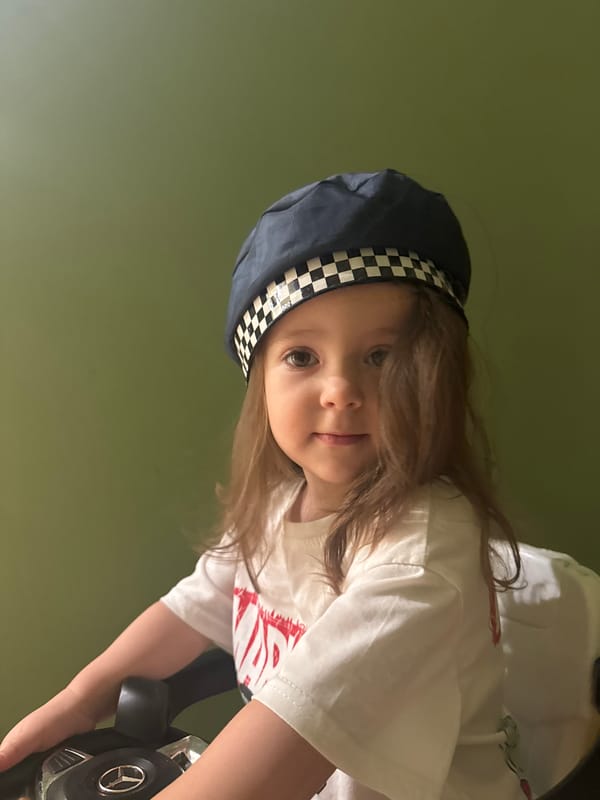 Child photographed in Beryozovka wearing distinctive checkered cap