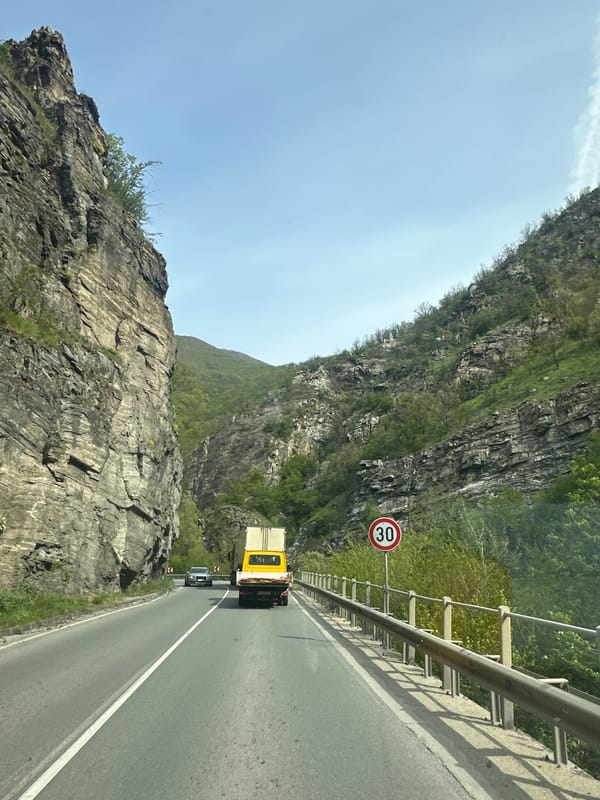 Motorist travels winding mountain road near Dorkovo, Bulgaria