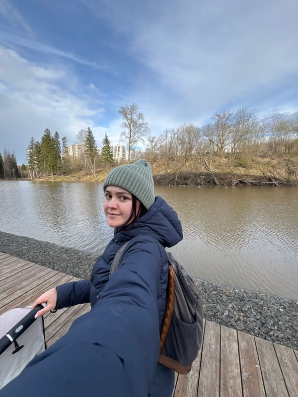 Woman photographed at peaceful lakeside walkway in Izhevsk