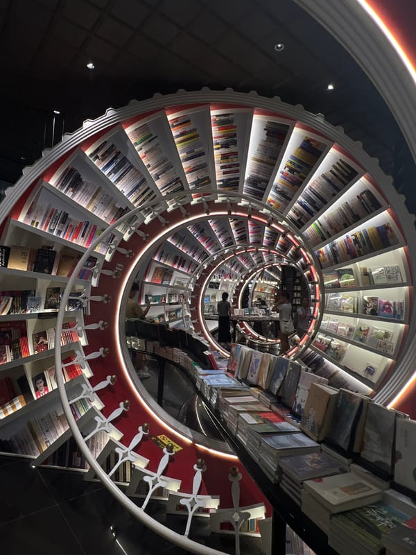 Woman with baby visits spiral staircase bookstore in Bao'an