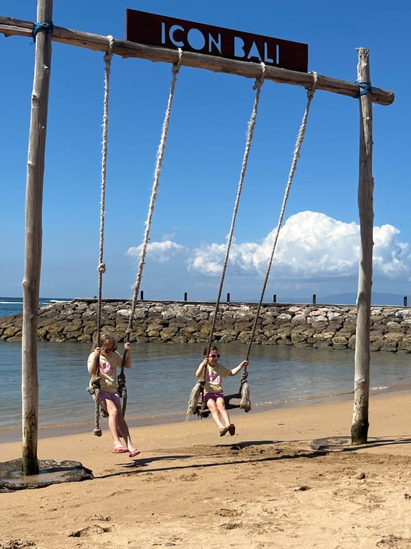 Wooden beach swings over the ocean near Denpasar, Bali
