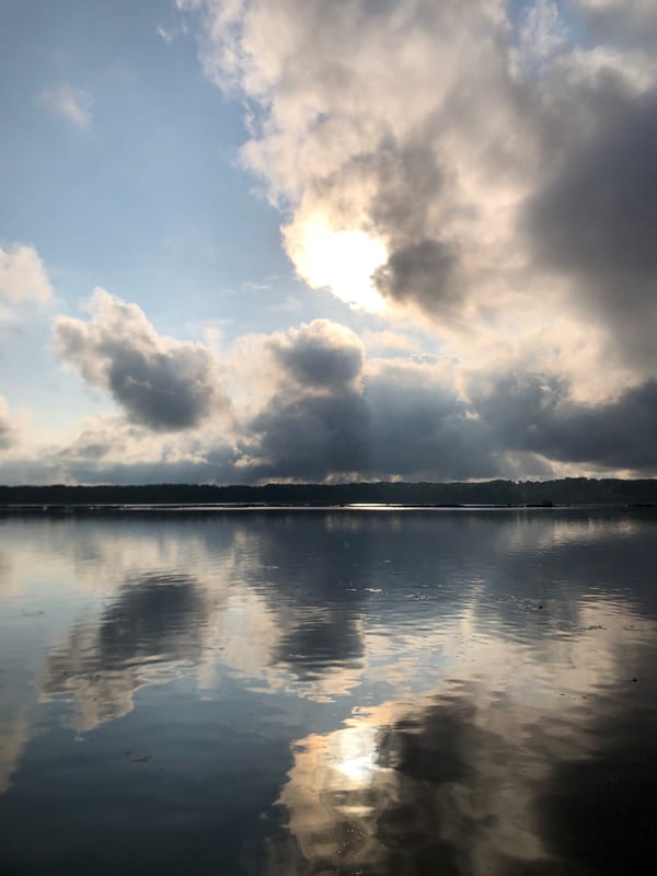 Overcast skies reflected across calm Russian waterways