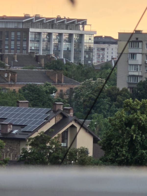 Rainy afternoon fades to dusk over a dense urban skyline