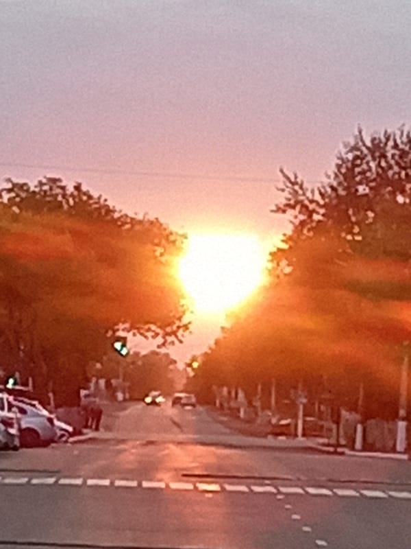 Sunset glow over a quiet street in Rudny, Kazakhstan