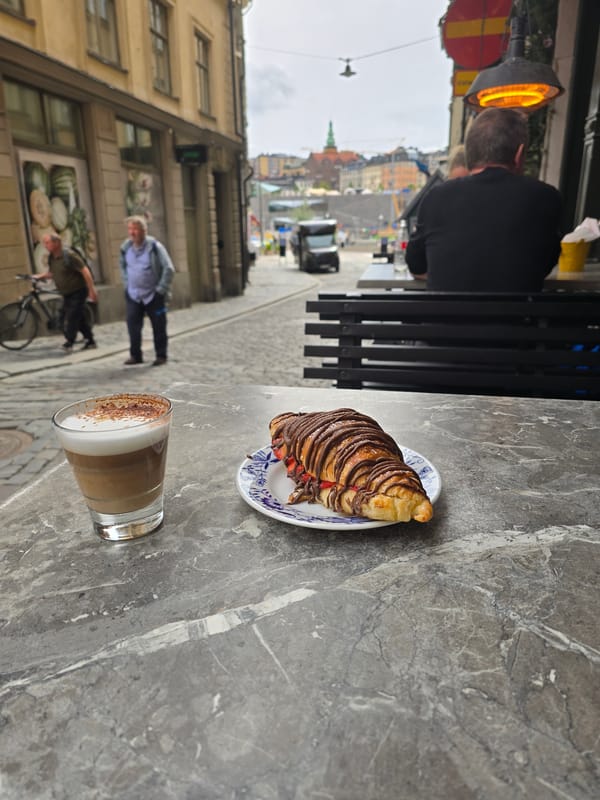 Visitor documents Stockholm's historic center during afternoon walkabout