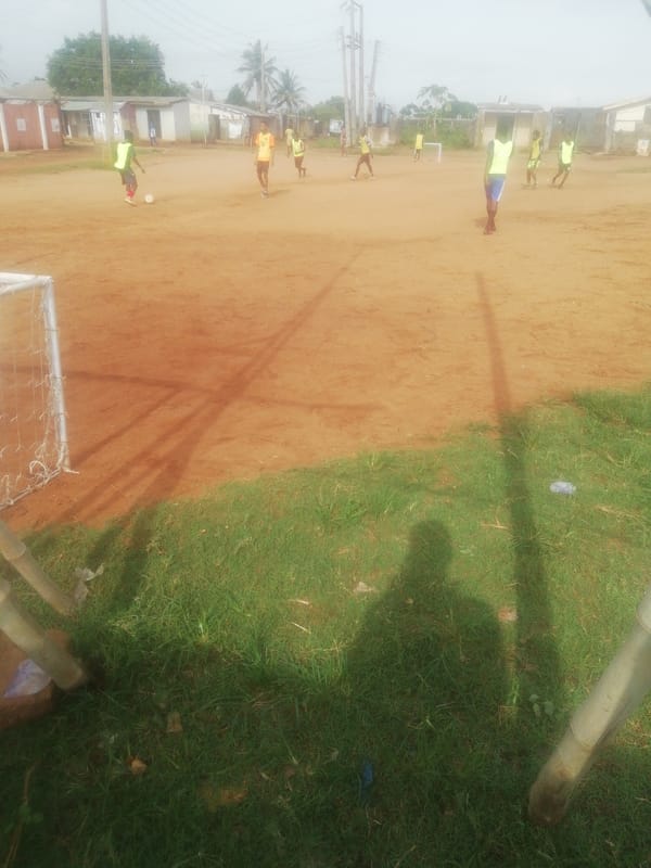Young players enjoy soccer game on dirt field in Ikorodu