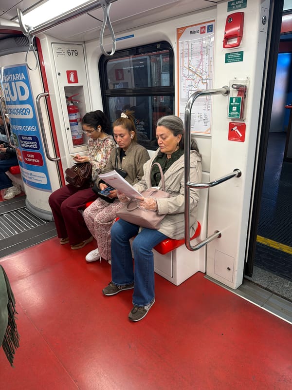 Three women ride Milan metro train together