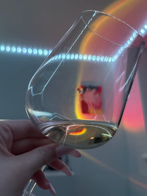 Person holds empty wine glass with blue lights, Russia
