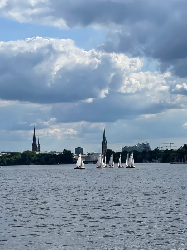 Sailboats spotted on Hamburg's Alster lake under sunny skies