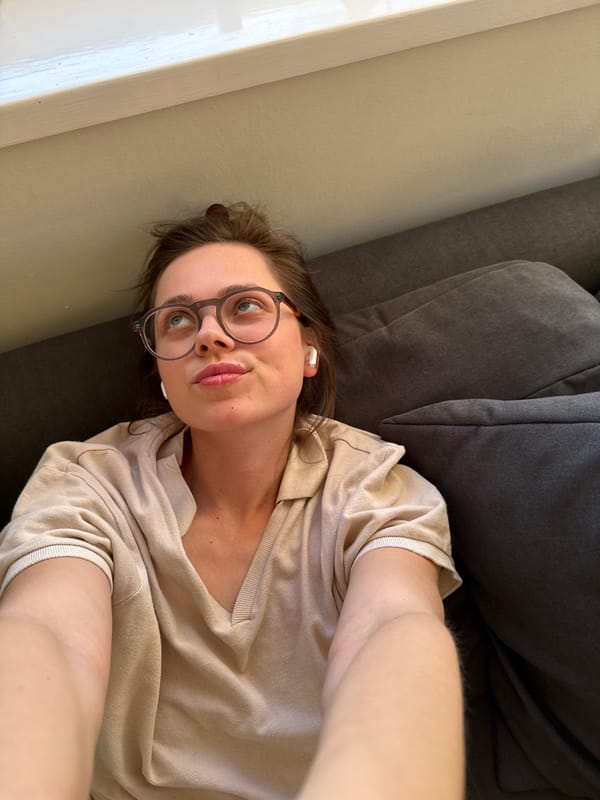 Woman takes casual selfies on couch in Budapest home