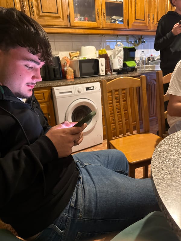 Young men gather in Bragança kitchen evening scene