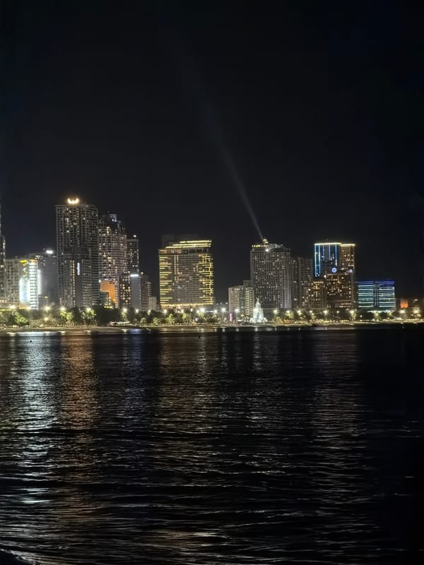 Friends enjoy nighttime beach picnic with sushi in Nha Trang